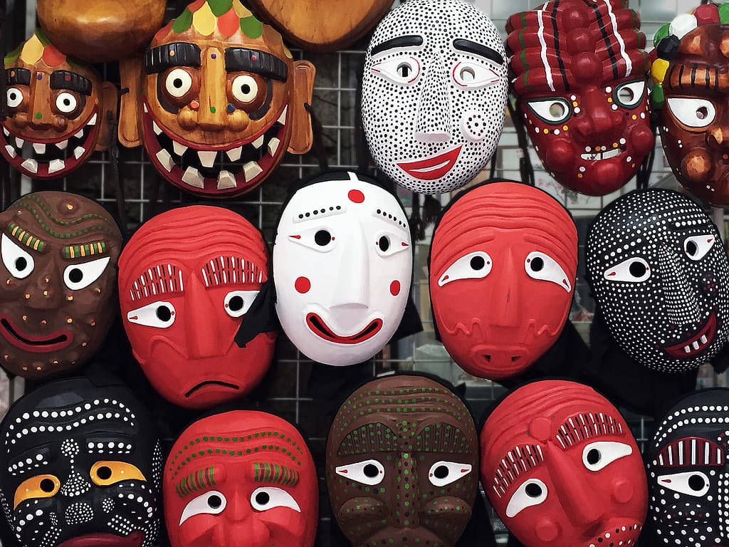 Variety of traditional folk masks from South Korea. A street vendor's display board of tal, masks, in Seoul.