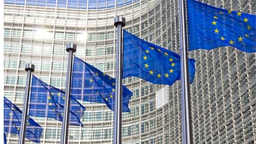 Picture of EU flags outside of buildings.